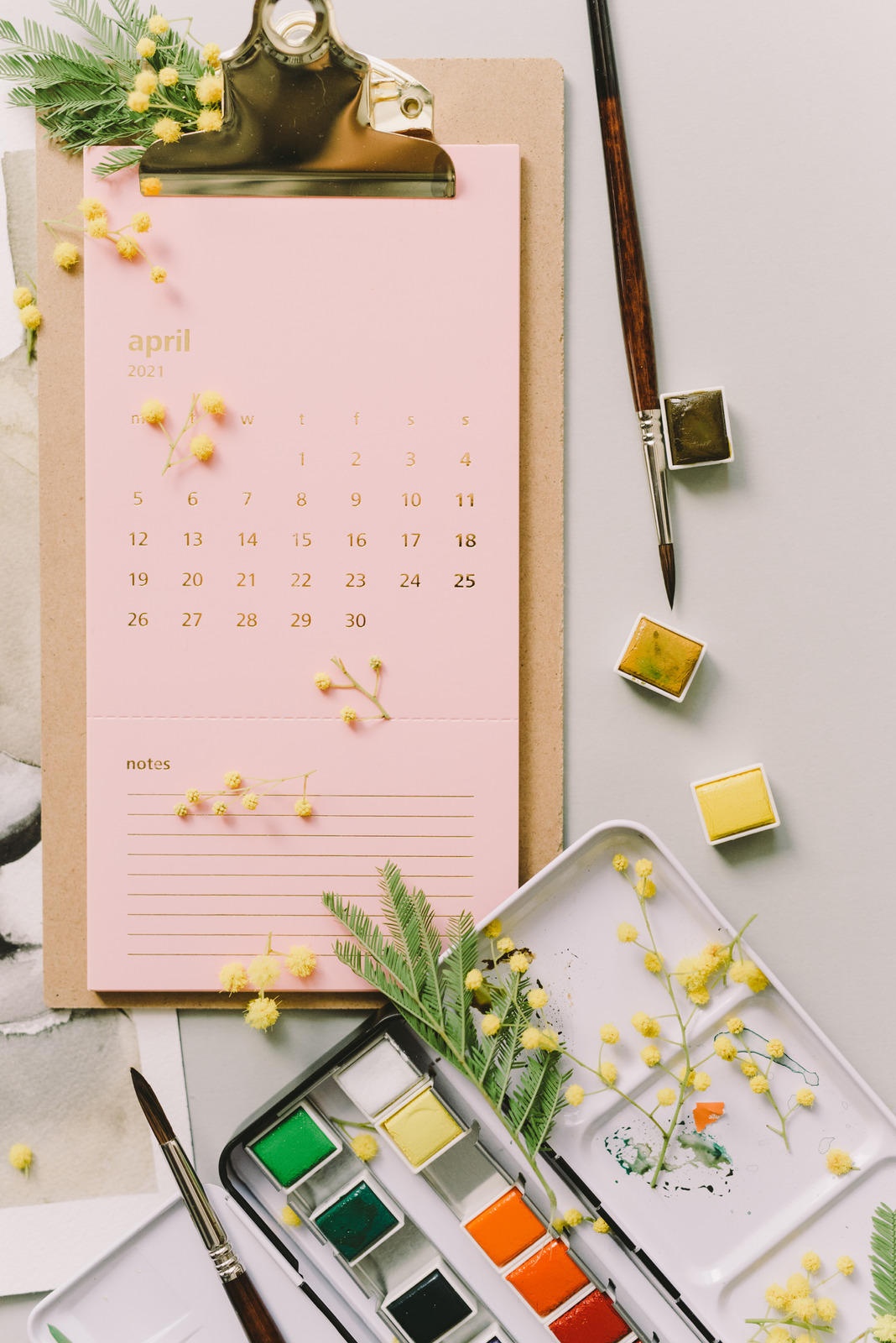 April calendar with paint supplies and flowers.